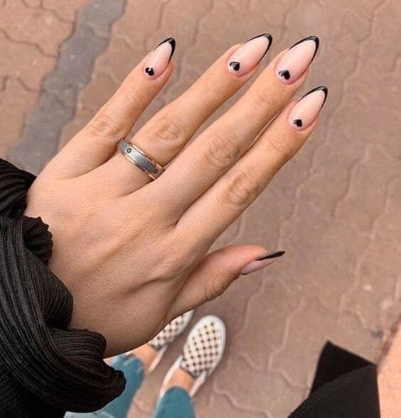 Black french tip nails with heart design.