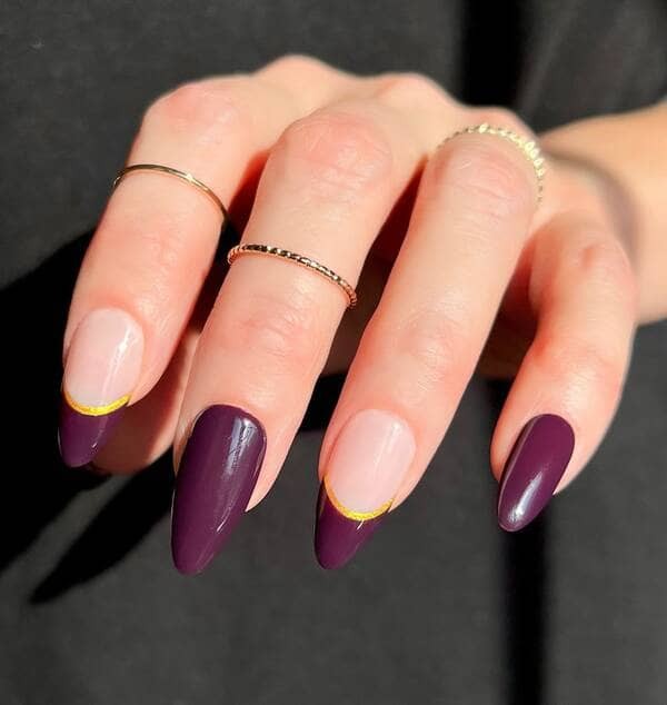 Burgundy and gold french nails.