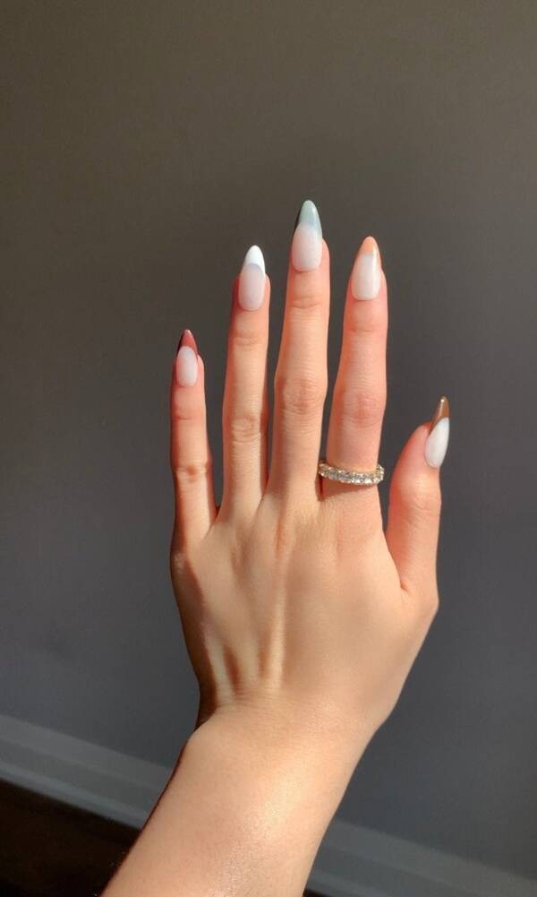 Nude mixed coloured nails.