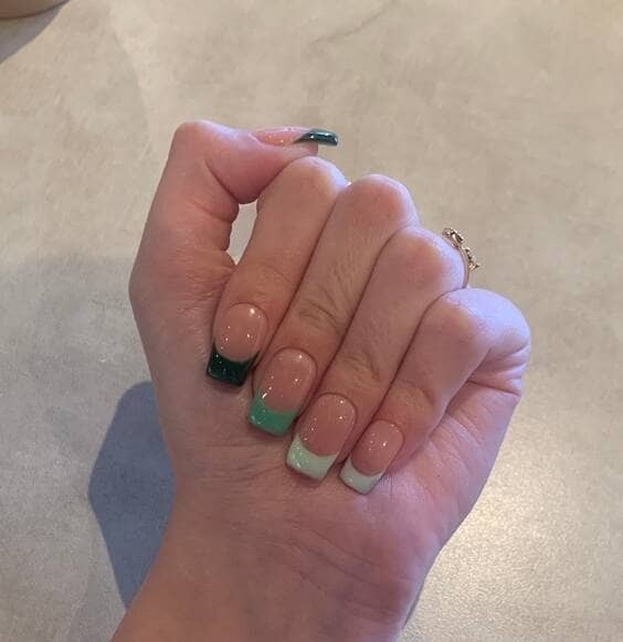 Green-rainbow french tip nails.