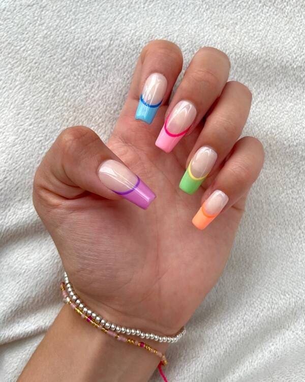 Multicoloured french rainbow nails.