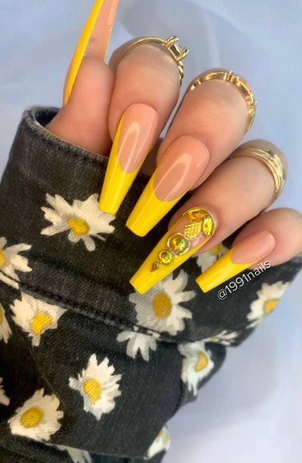 French tips yellow nails with rhinestones.