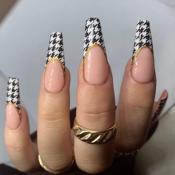 Houndstooth french tip nails with gold detailing.