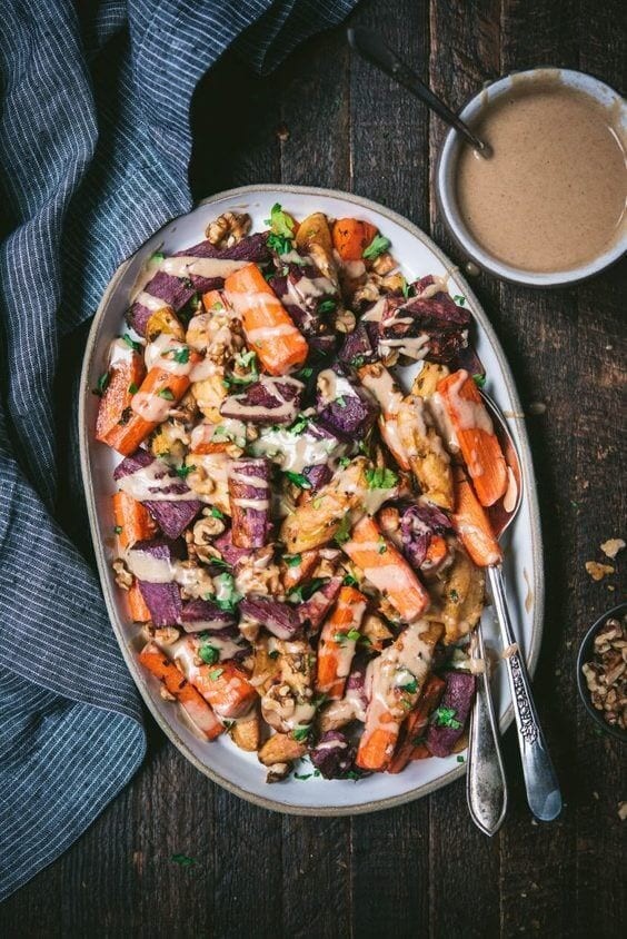 Roasted carrots, apples, and sweet potatoes with a cinnamon tahini drizzle.