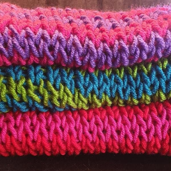 Funky chunky bright hand-knit blanket with tassels.