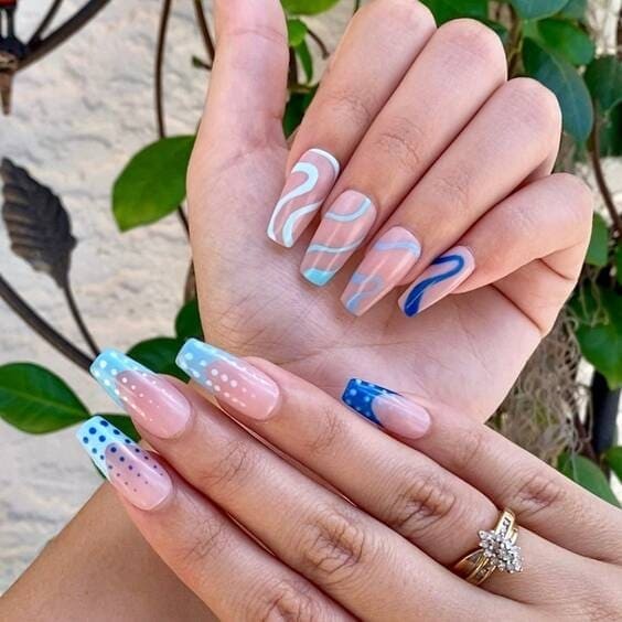 Blue abstract and french tip mismatch nails.