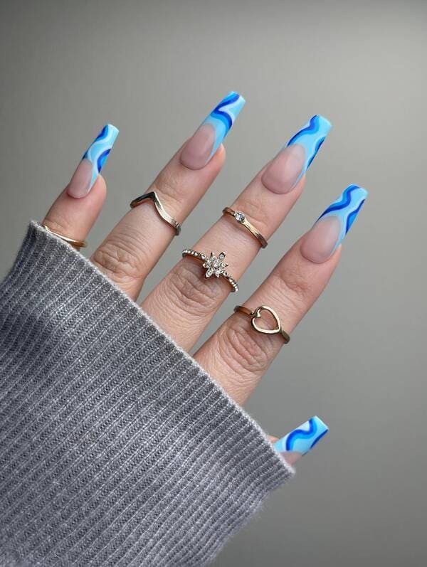 Aqua blue french tip nails with swirls.