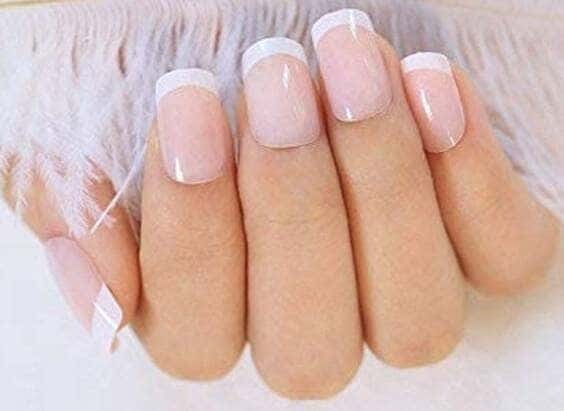 Sheer nude acrylic medium-length nails.