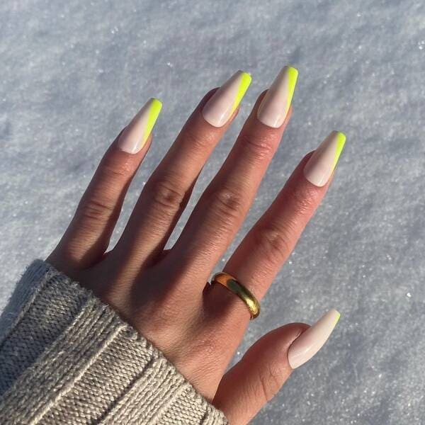 Yellowy green colored french tip nails.