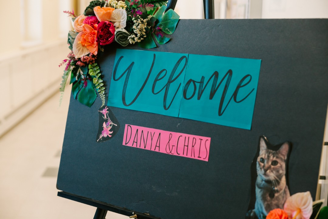 Danya and Chris had an intimate DIY wedding with vibrant hues that suited their personalities perfectly. They are both huge animal lovers, so having the zoo be their wedding venue just made sense. So did featuring their adorable cat in many aspects of their wedding theme decor! Don