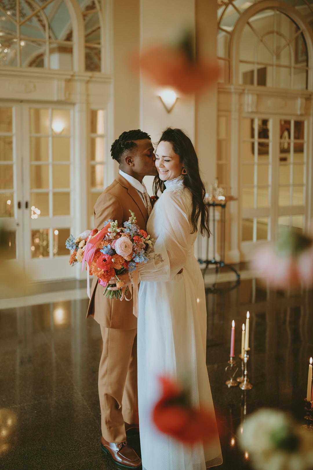 This floral circle arch plus candlelit aisle make a simple, 70s-inspired statement for a spring wedding.