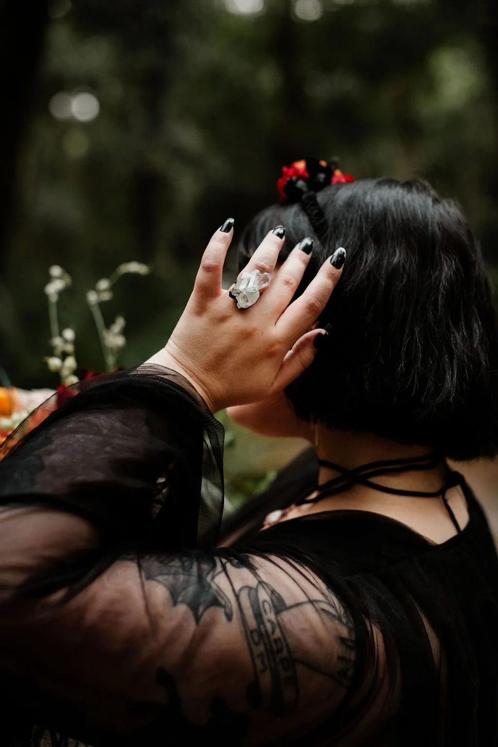 First up: Black wedding dress with that headdress, that Halloween wedding bouquet, and that quartz ring…