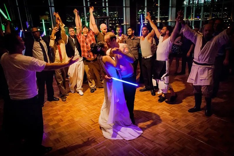 The best end to a Star Wars wedding: shirtless groom and a light saber