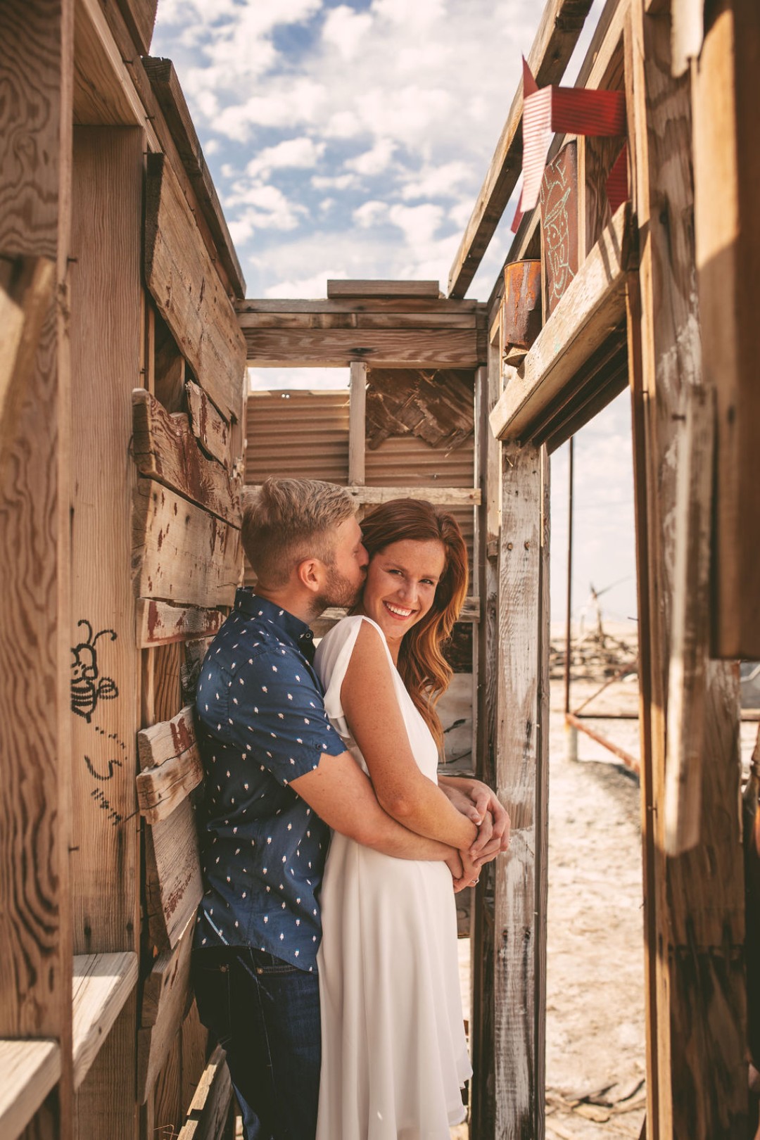 The couple snuck a kiss in a little shanty by the sea for their engagement photo shoot. That just screams artistic engagement photos!