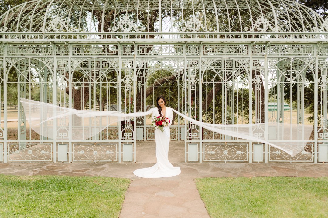 And OMG this long-sleeved wedding dress with trailing tulle wings. Can you imagine how this would look if you wore this while flying on a dragon?!