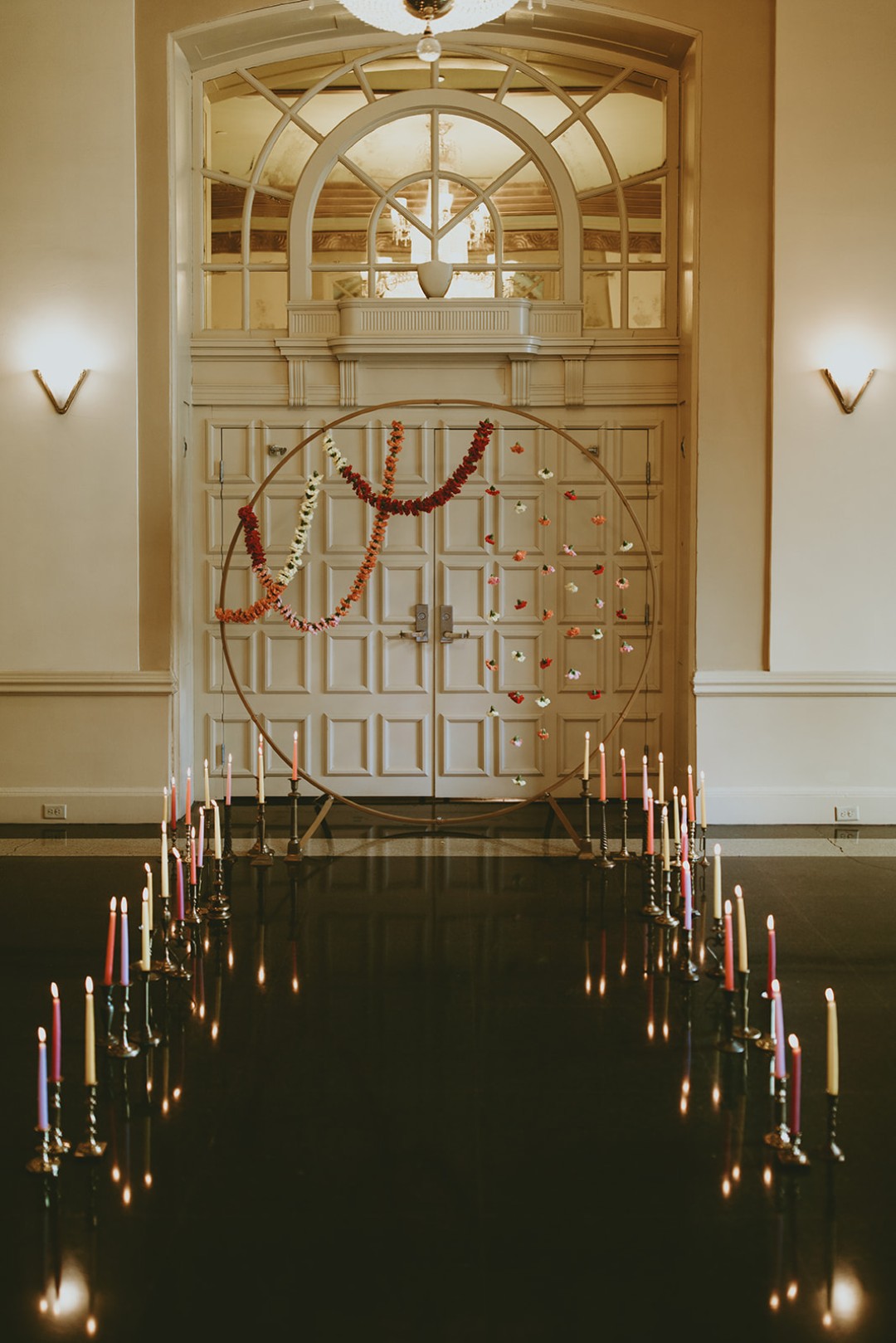 This floral circle arch plus candlelit aisle make a simple, 70s-inspired statement for a spring wedding.