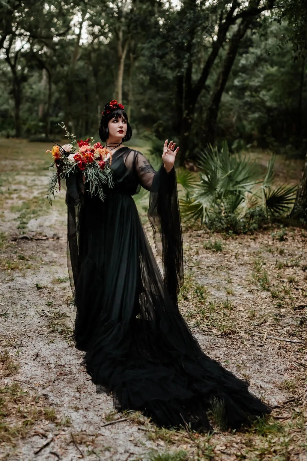 First up: Black wedding dress with that headdress, that Halloween wedding bouquet, and that quartz ring…