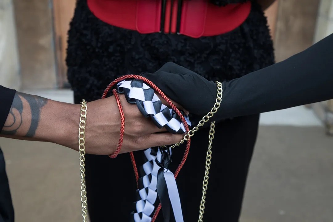 And now for the handfasting ceremony featuring red, black, and white cords plus a gold chain.