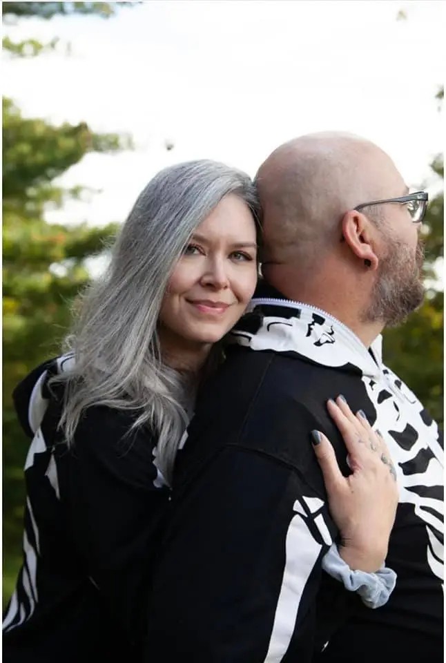 Rocking silver hair in a skeleton onesie at a cemetery? We