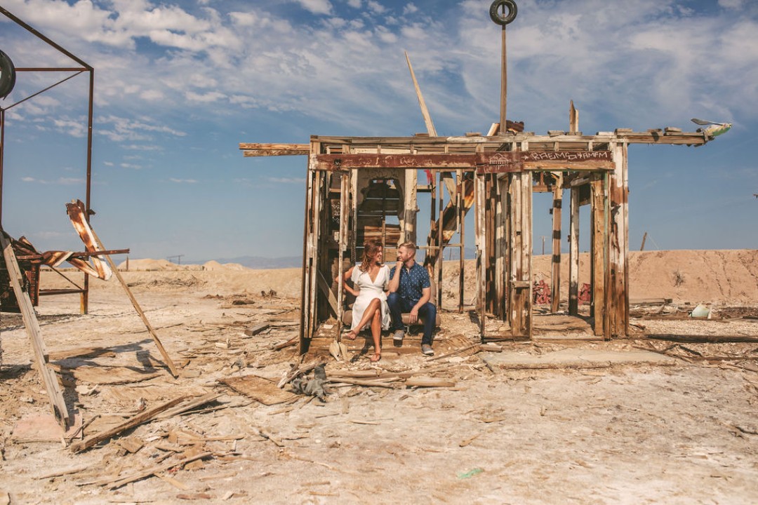 The couple snuck a kiss in a little shanty by the sea for their engagement photo shoot. That just screams artistic engagement photos!